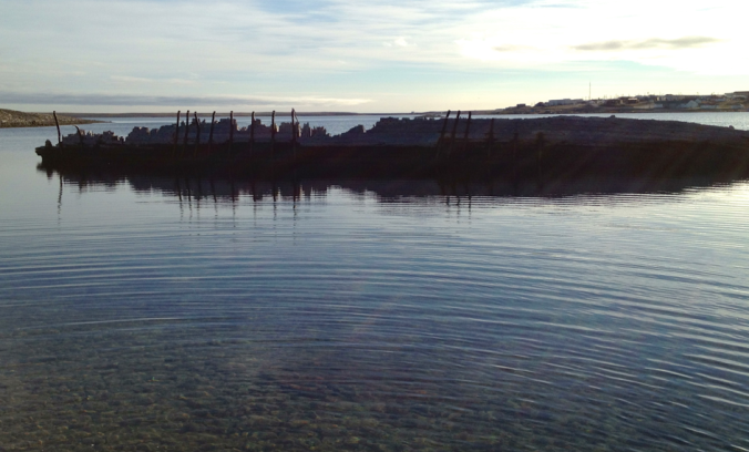The Maud, in its resting place. The townsite of Cambridge Bay is visible in the background