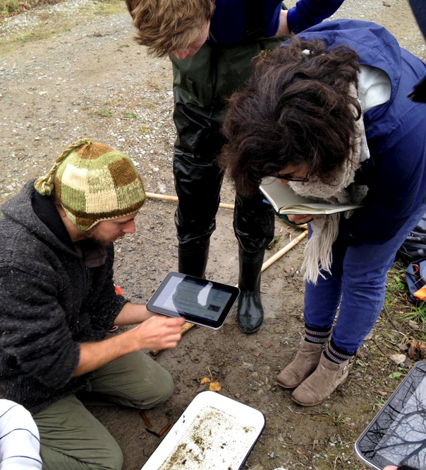A group using a Toshiba tablet to help identify an aquatic invertebrate